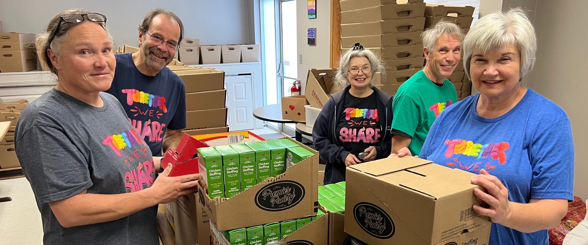 Volunteers and staff organizing holiday food boxes