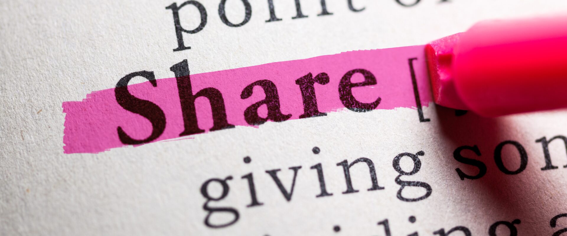 Pink highlighter highlighting the word Share in a dictionary