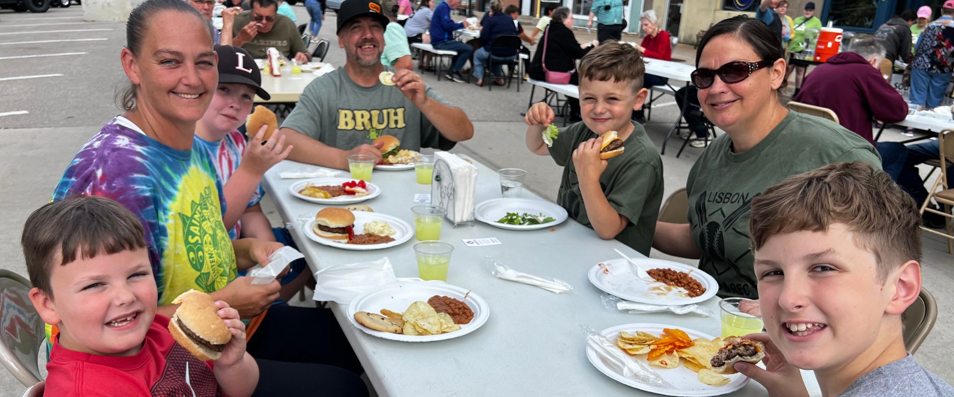 Family enjoying meal at table outside