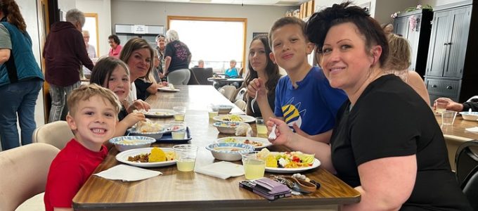 Families enjoying meal at Community Eats!